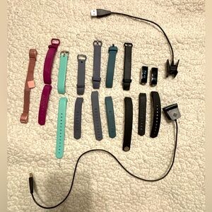 Fitbit Alta and Fitbit Alta HR  with chargers and assortment of bands
